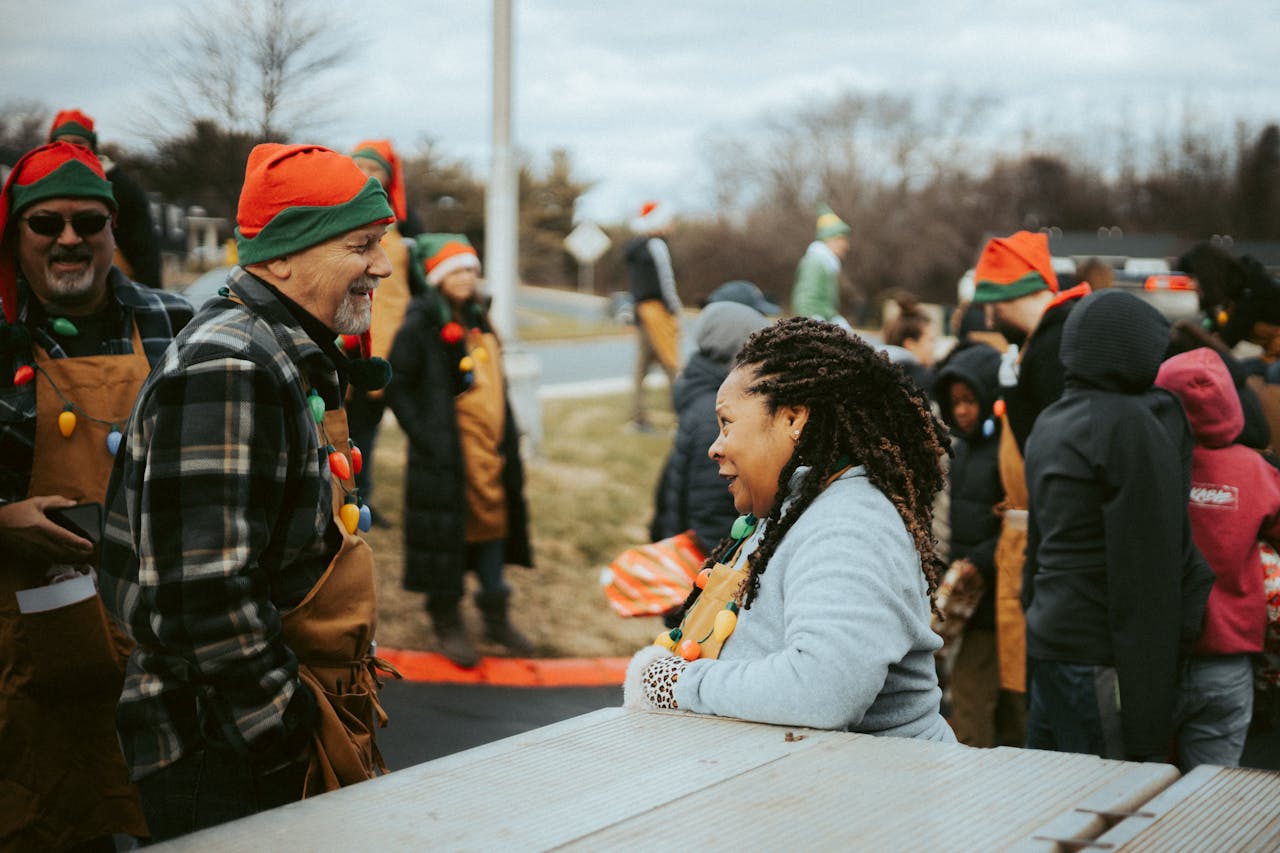 gallery-6 A joyful outdoor holiday event featuring people in festive Christmas elf costumes.